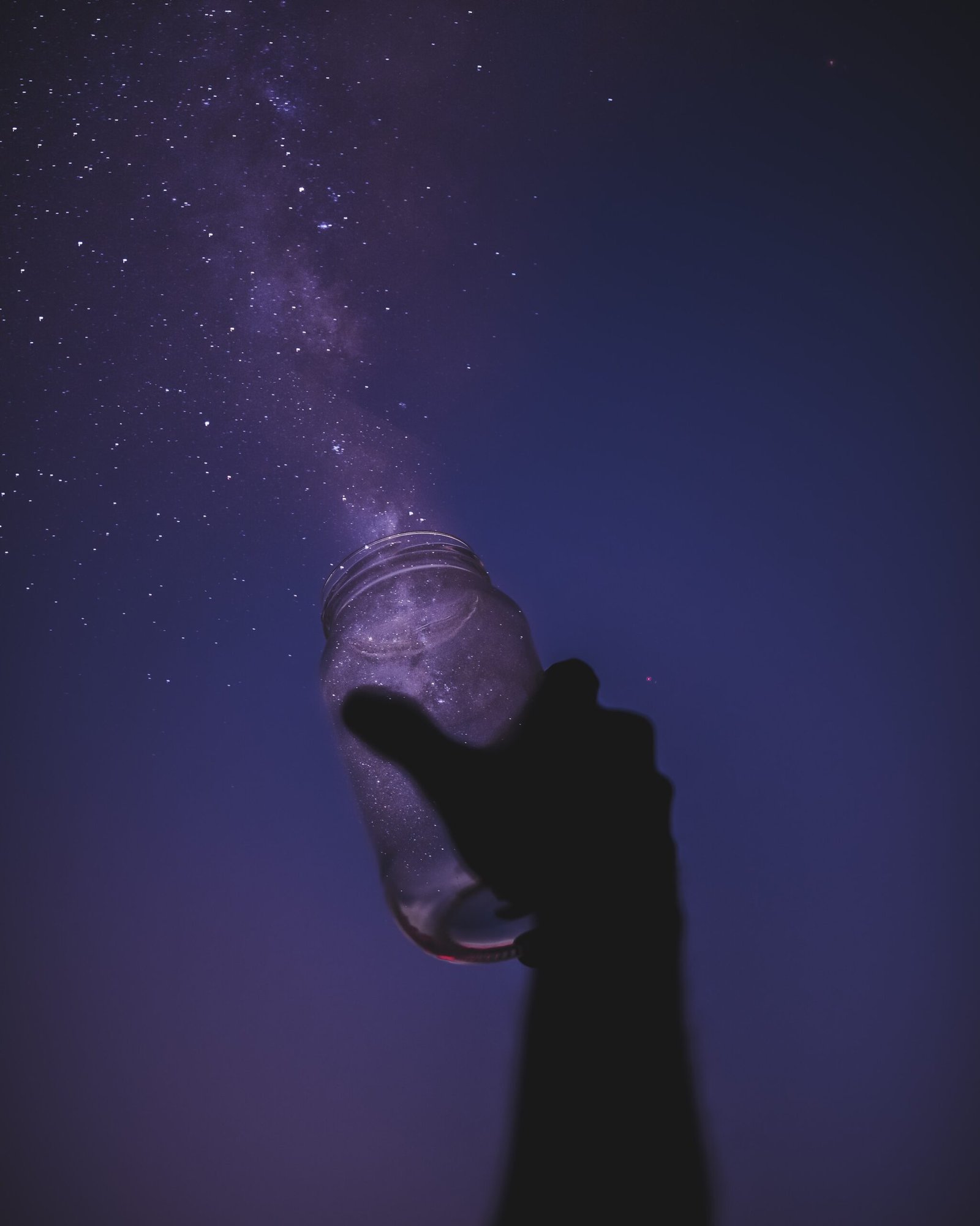 person holding glass jar